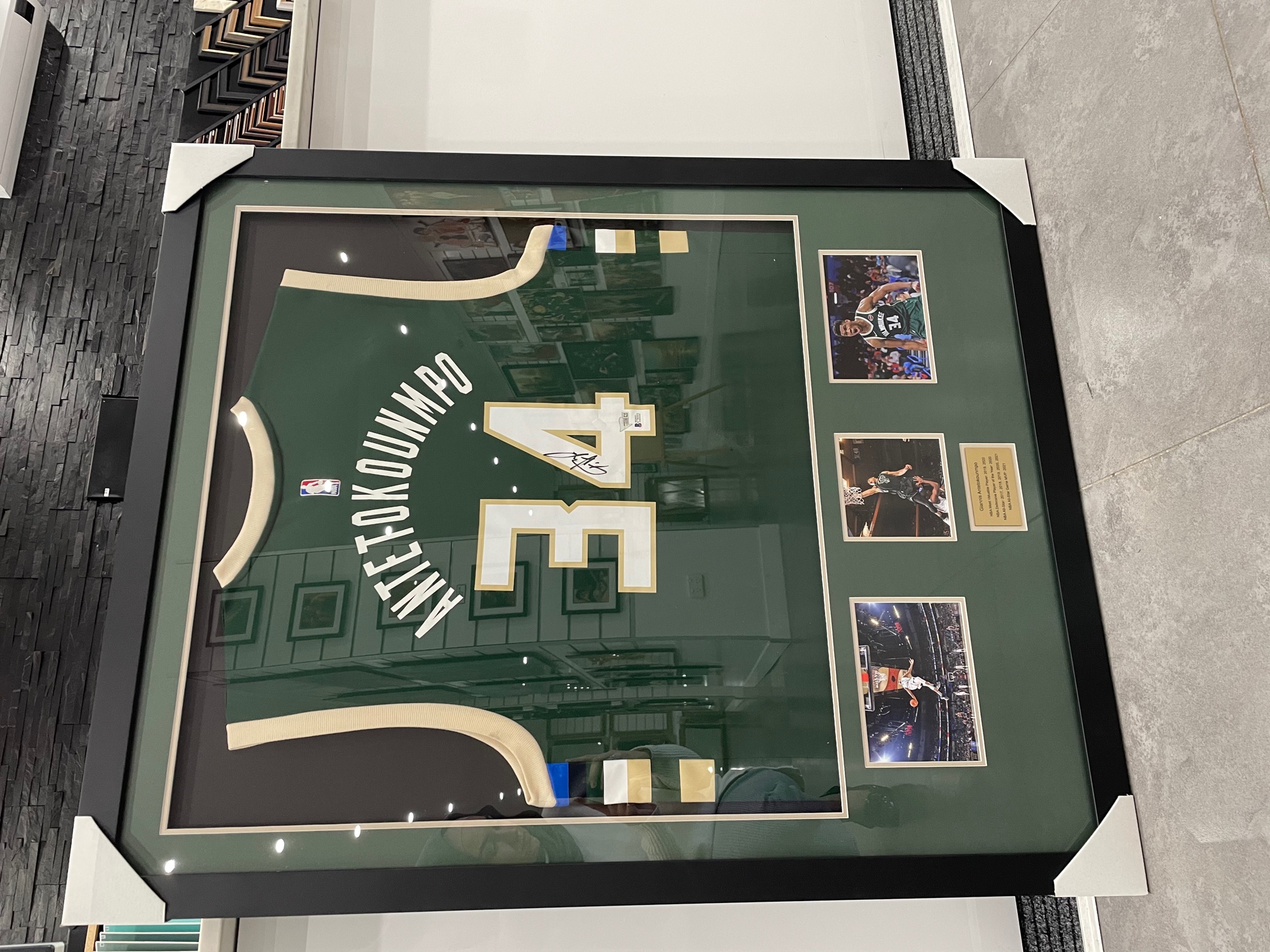 Basketball jersey framed with photos and plaque